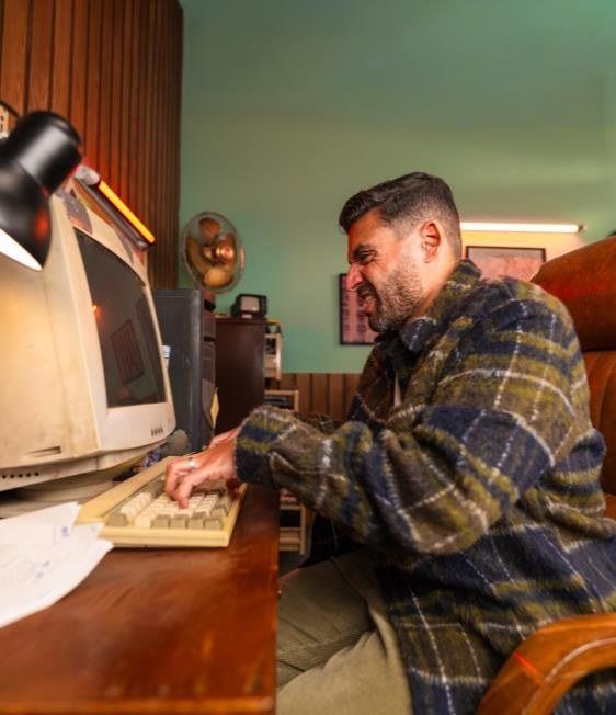 Islam Fawzy at an old office computer
